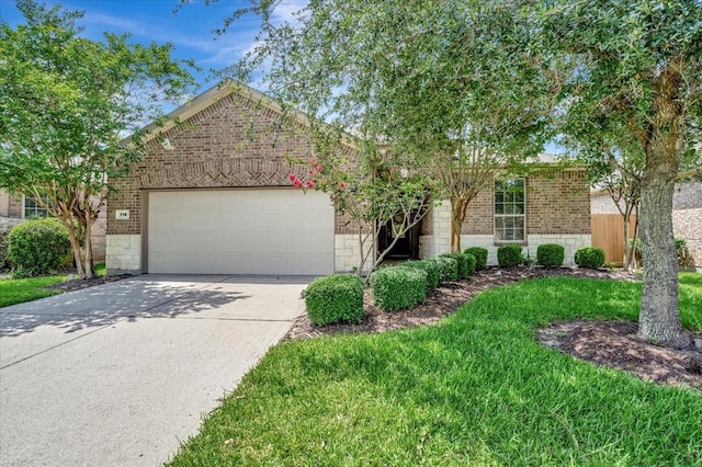 716 Saturnia Ln, League City, TX 77573 - view of property hidden behind natural elements with brick siding, a garage, concrete driveway, and stone siding
