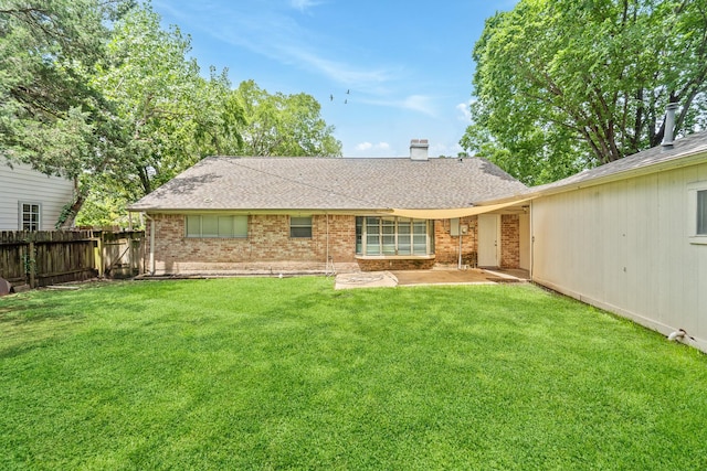 11826 Bandlon Dr, Houston, TX 77072 - back of property featuring roof with shingles, brick siding, a chimney, and a patio area