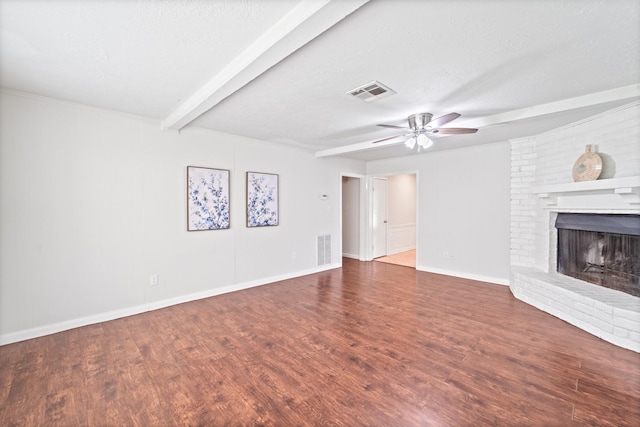 11826 Bandlon Dr, Houston, TX 77072 - unfurnished living room with a ceiling fan, beamed ceiling, a brick fireplace, wood finished floors, and a textured ceiling