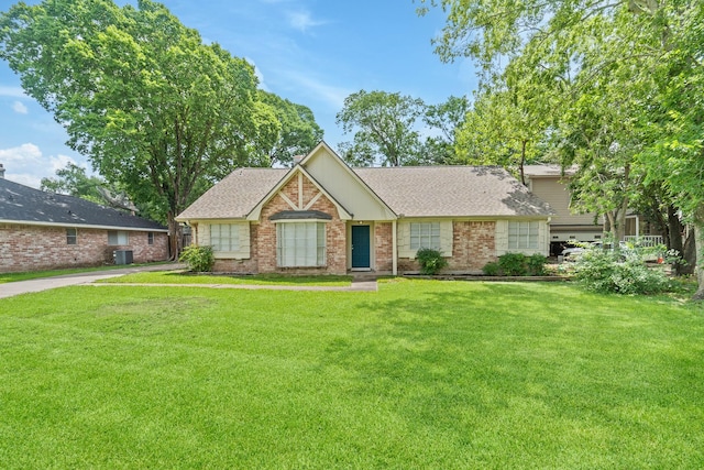 11826 Bandlon Dr, Houston, TX 77072 - view of front facade featuring a front yard, brick siding, and a shingled roof