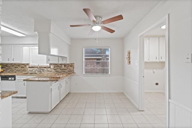 11826 Bandlon Dr, Houston, TX 77072 - kitchen featuring white cabinets, ceiling fan, tasteful backsplash, a peninsula, and light stone counters
