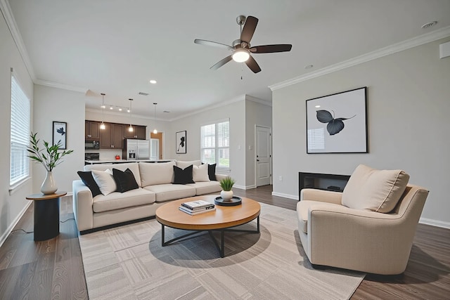 915 Lakeland Cir, Rosharon, TX 77583 - living room with light wood-style floors, ornamental molding, ceiling fan, and recessed lighting
