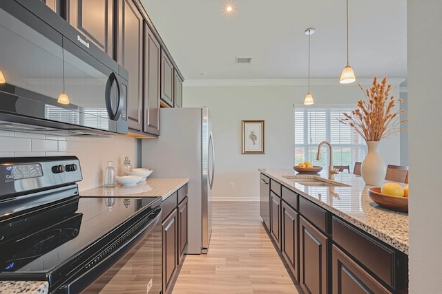 915 Lakeland Cir, Rosharon, TX 77583 - kitchen featuring appliances with stainless steel finishes, backsplash, light wood-style flooring, light stone counters, and crown molding