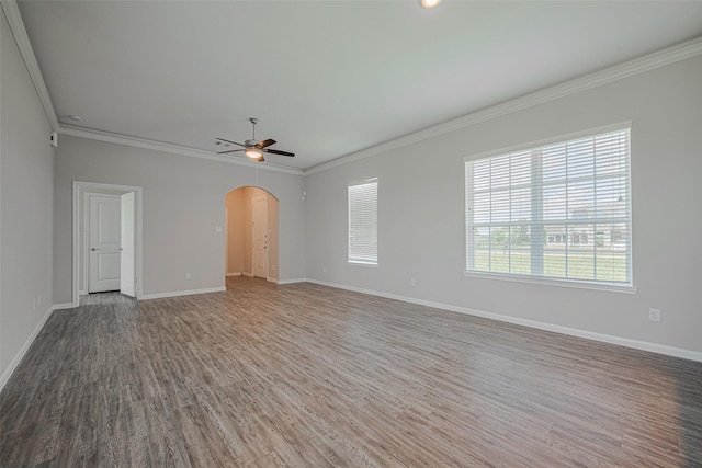 915 Lakeland Cir, Rosharon, TX 77583 - unfurnished room featuring arched walkways, a ceiling fan, wood finished floors, and crown molding