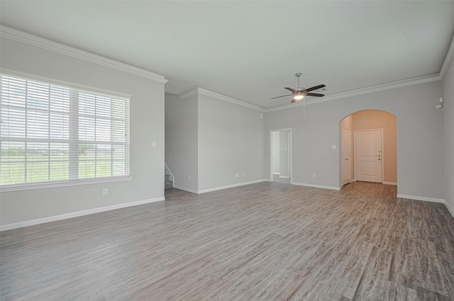 915 Lakeland Cir, Rosharon, TX 77583 - spare room featuring a ceiling fan, wood finished floors, crown molding, arched walkways, and stairs
