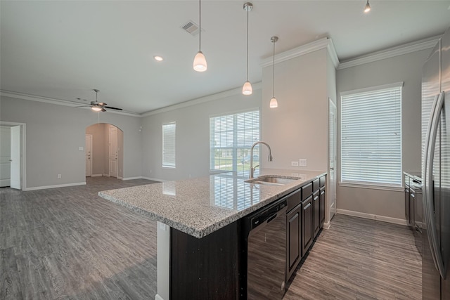 915 Lakeland Cir, Rosharon, TX 77583 - kitchen with dishwasher, arched walkways, wood finished floors, ornamental molding, and light stone counters