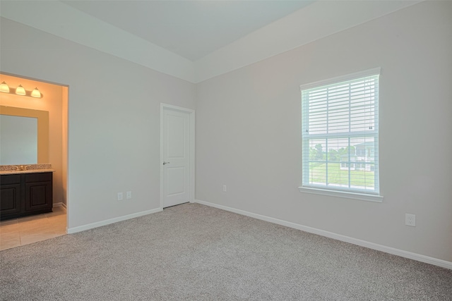 915 Lakeland Cir, Rosharon, TX 77583 - unfurnished bedroom featuring light colored carpet and ensuite bath