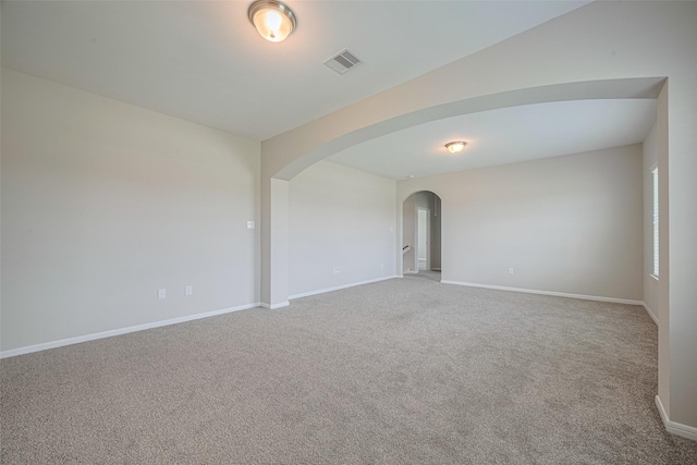 915 Lakeland Cir, Rosharon, TX 77583 - carpeted empty room featuring arched walkways and baseboards