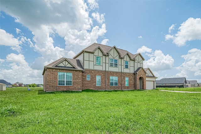 915 Lakeland Cir, Rosharon, TX 77583 - tudor home with a garage, a front yard, brick siding, and stucco siding