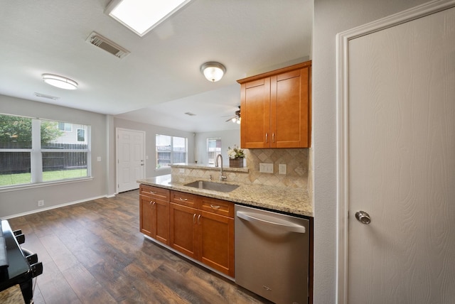 10335 Caribou Cv, Missouri City, TX 77459 - kitchen featuring dishwasher, brown cabinetry, decorative backsplash, and healthy amount of natural light