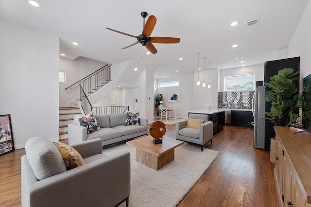 1211 Bonner St, Houston, TX 77007 - living area featuring wood finished floors, a ceiling fan, stairway, and recessed lighting
