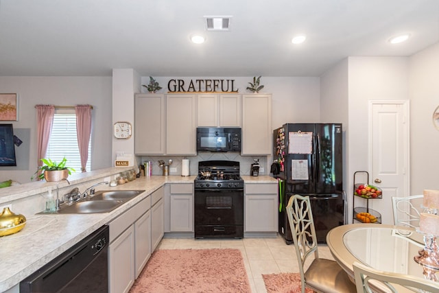4430 Misty Woods Trl, Richmond, TX 77469 - kitchen featuring black appliances, light countertops, tasteful backsplash, light tile patterned floors, and gray cabinets