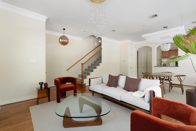 9103 Creekstone Lake Dr, Houston, TX 77054 - living room with ornamental molding, arched walkways, wood finished floors, stairs, and a chandelier