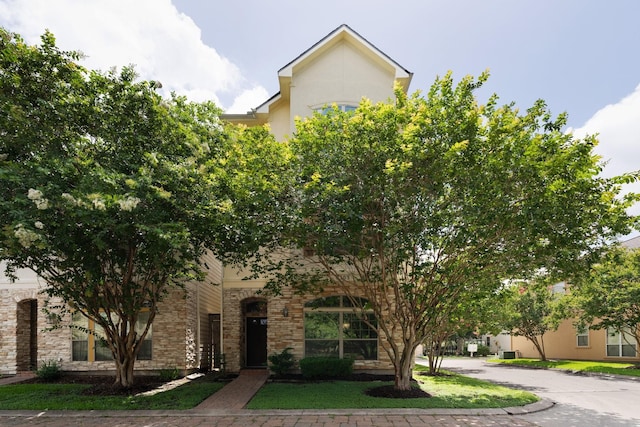 9103 Creekstone Lake Dr, Houston, TX 77054 - view of property hidden behind natural elements with stone siding