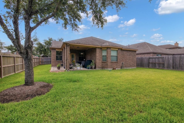 3215 W Trail Dr, Pearland, TX 77584 - back of house featuring brick siding, a patio area, and a fenced backyard