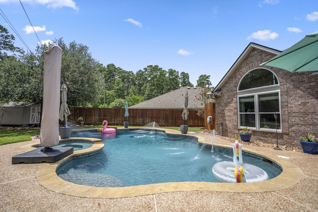 9227 Forest Creek Dr, Tomball, TX 77375 - view of pool with a fenced backyard, a storage unit, a patio, and a pool with connected hot tub