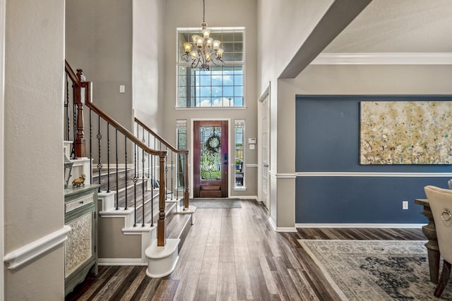 9227 Forest Creek Dr, Tomball, TX 77375 - foyer entrance with a chandelier, stairs, wood finished floors, a high ceiling, and ornamental molding