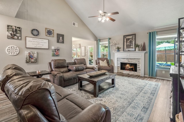 9227 Forest Creek Dr, Tomball, TX 77375 - living area featuring a fireplace, a ceiling fan, hardwood / wood-style flooring, and high vaulted ceiling