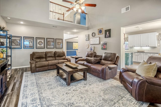 9227 Forest Creek Dr, Tomball, TX 77375 - living room with wood finished floors, ceiling fan, a high ceiling, and recessed lighting