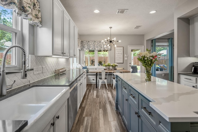 9227 Forest Creek Dr, Tomball, TX 77375 - kitchen featuring dark wood-type flooring, recessed lighting, a chandelier, decorative backsplash, and white cabinets