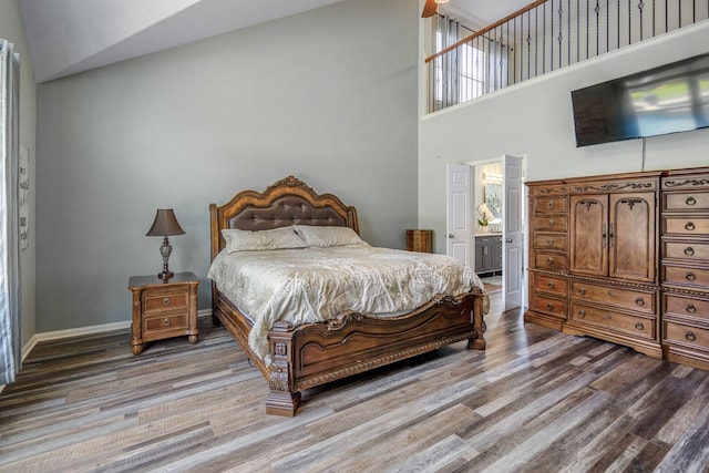 9227 Forest Creek Dr, Tomball, TX 77375 - bedroom with wood finished floors, high vaulted ceiling, and ensuite bathroom