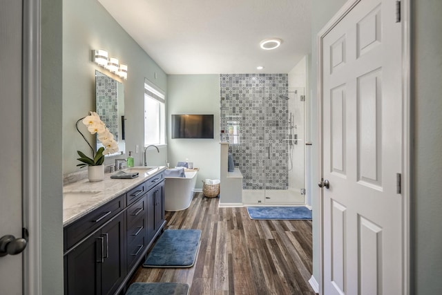 9227 Forest Creek Dr, Tomball, TX 77375 - bathroom featuring a shower stall, double vanity, a soaking tub, and wood finished floors