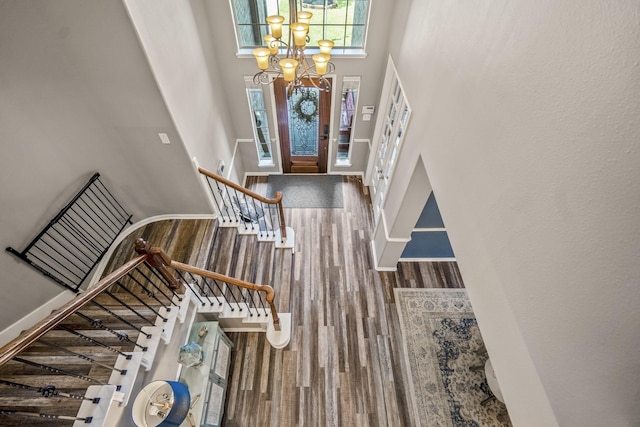 9227 Forest Creek Dr, Tomball, TX 77375 - foyer entrance with a towering ceiling, a chandelier, wood finished floors, and stairs