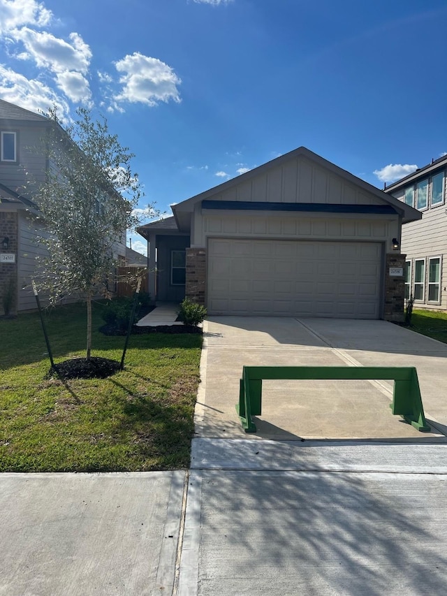 526 Emerald Thicket Ln, Huffman, TX 77336 - view of front of house with driveway, board and batten siding, an attached garage, a front lawn, and brick siding