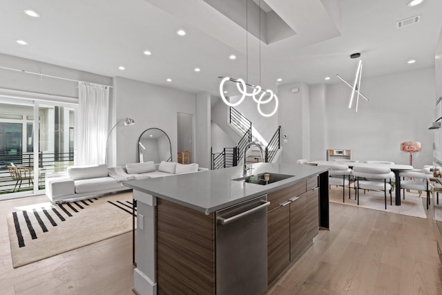 1617 Wheeler St Unit C, Houston, TX 77004 - kitchen with stainless steel dishwasher, modern cabinets, open floor plan, an island with sink, and light wood finished floors