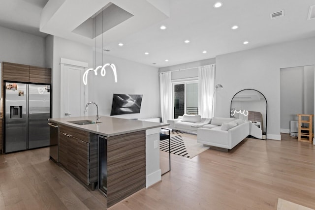 1617 Wheeler St Unit C, Houston, TX 77004 - kitchen featuring appliances with stainless steel finishes, modern cabinets, recessed lighting, open floor plan, and light wood-type flooring