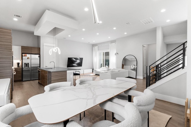 1617 Wheeler St Unit C, Houston, TX 77004 - dining room with light wood-type flooring, recessed lighting, and stairway