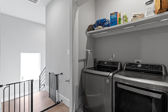 1617 Wheeler St Unit C, Houston, TX 77004 - washroom featuring separate washer and dryer and light wood-type flooring