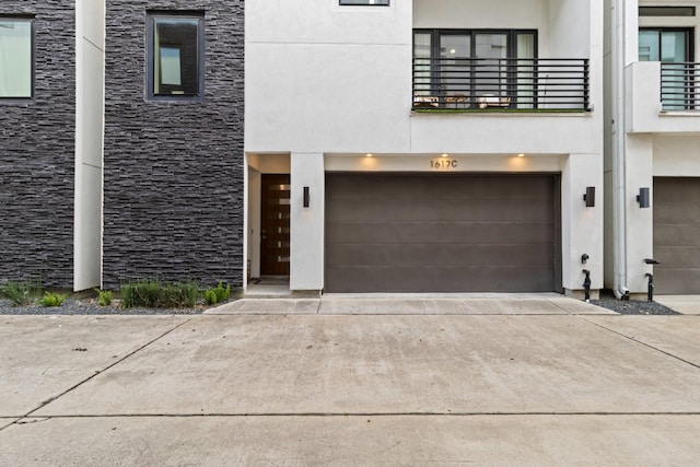 1617 Wheeler St Unit C, Houston, TX 77004 - view of front of house with a garage, concrete driveway, stone siding, and stucco siding