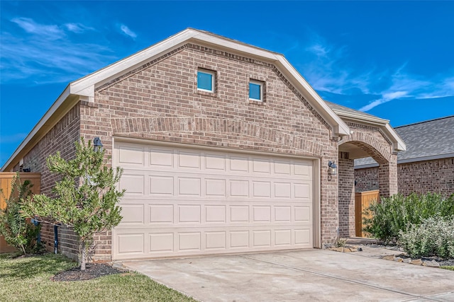 1452 Sundown Glen Ln, Katy, TX 77493 - view of front facade featuring brick siding, concrete driveway, a garage, and roof with shingles