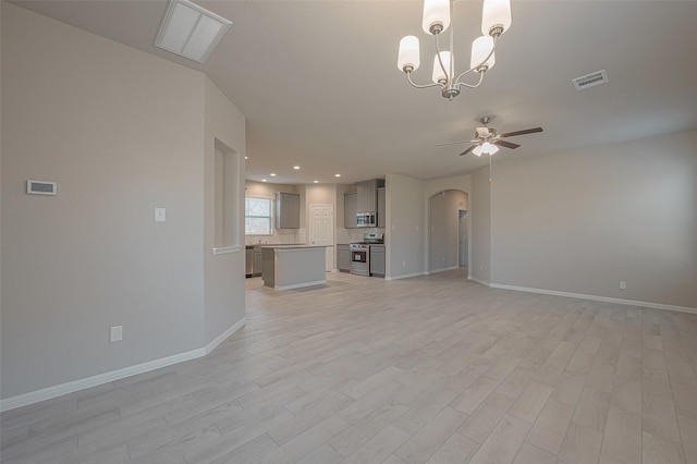 1452 Sundown Glen Ln, Katy, TX 77493 - unfurnished living room with arched walkways, ceiling fan, light wood-style flooring, a chandelier, and recessed lighting