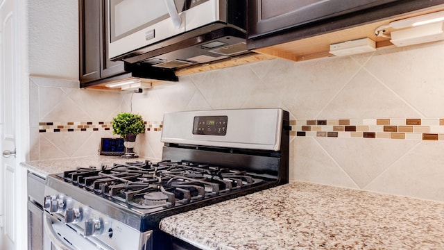 4407 Crosley Field Dr, Spring, TX 77389 - kitchen with appliances with stainless steel finishes, dark brown cabinetry, backsplash, and light stone countertops