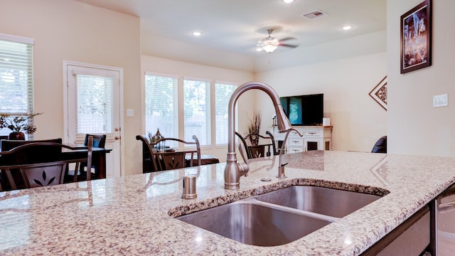 4407 Crosley Field Dr, Spring, TX 77389 - kitchen featuring light stone counters, ceiling fan, healthy amount of natural light, and recessed lighting