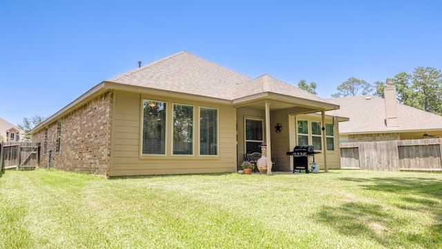 4407 Crosley Field Dr, Spring, TX 77389 - back of property featuring a fenced backyard, brick siding, and a shingled roof