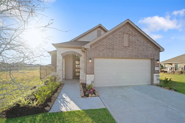 1468 Sundown Glen Dr, Katy, TX 77493 - view of front of home featuring brick siding, a garage, and driveway