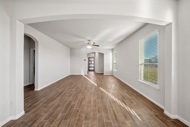 1468 Sundown Glen Dr, Katy, TX 77493 - unfurnished living room with arched walkways, dark wood-style floors, and ceiling fan