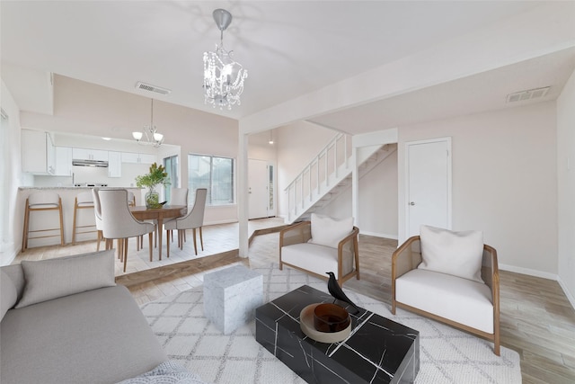 12606 Wellington Park Dr, Houston, TX 77072 - living area featuring a chandelier, stairway, and light wood-style floors