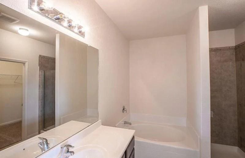 15302 Albert Oak Dr, Humble, TX 77396 - full bathroom with a bath, vanity, a shower stall, and a walk in closet