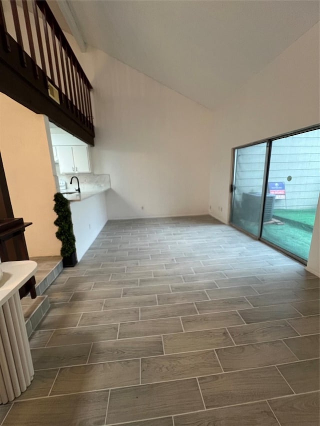 12922 Wirevine Ln, Houston, TX 77072 - unfurnished living room with vaulted ceiling and wood tiled floors
