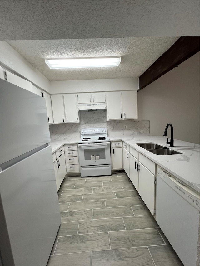 12922 Wirevine Ln, Houston, TX 77072 - kitchen with white appliances, under cabinet range hood, white cabinetry, a textured ceiling, and tasteful backsplash