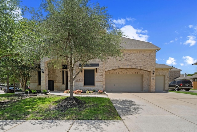 4314 Walden Terrace Ln, Humble, TX 77396 - view of front of property featuring brick siding, an attached garage, driveway, and a shingled roof