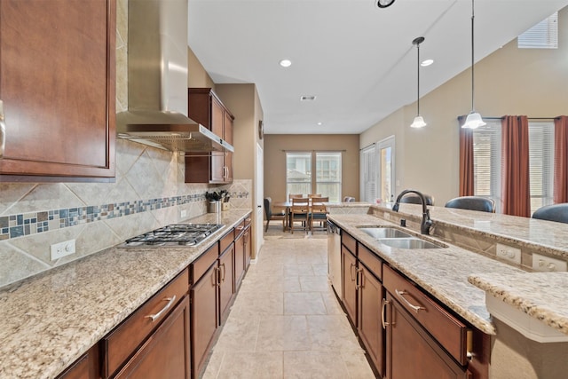 4314 Walden Terrace Ln, Humble, TX 77396 - kitchen featuring wall chimney range hood, stainless steel appliances, decorative backsplash, decorative light fixtures, and light stone counters