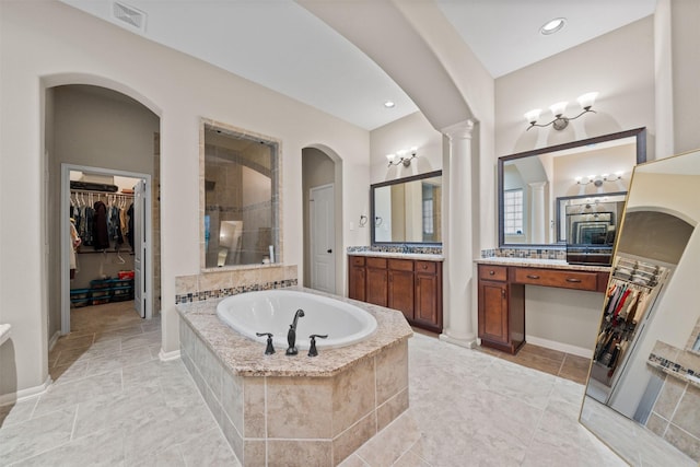 4314 Walden Terrace Ln, Humble, TX 77396 - bathroom with a bath, a stall shower, decorative columns, a walk in closet, and recessed lighting