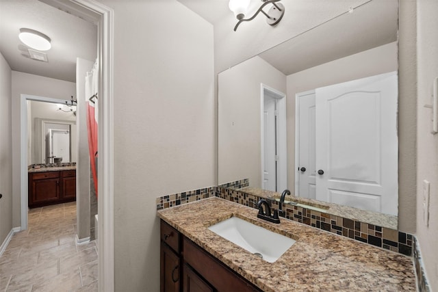 4314 Walden Terrace Ln, Humble, TX 77396 - bathroom featuring vanity, curtained shower, and stone finish flooring