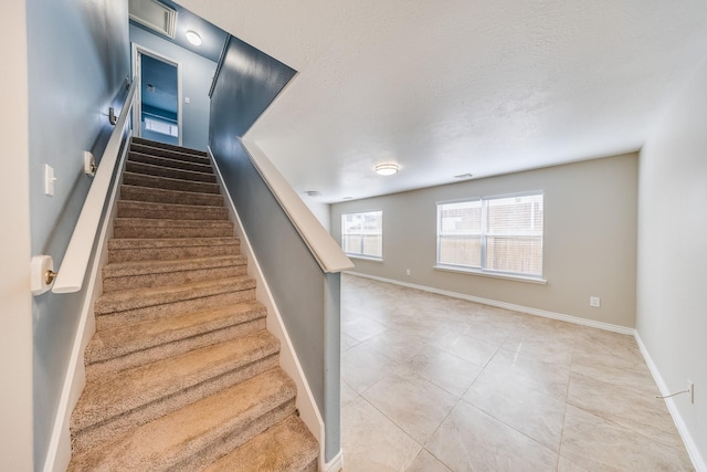 12511 Garden Gale Ln, Houston, TX 77044 - staircase with tile patterned flooring and a textured ceiling