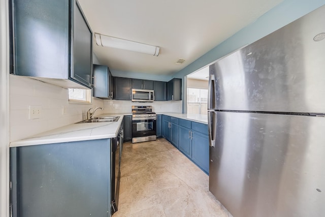 12511 Garden Gale Ln, Houston, TX 77044 - kitchen featuring appliances with stainless steel finishes, healthy amount of natural light, blue cabinets, and light stone counters